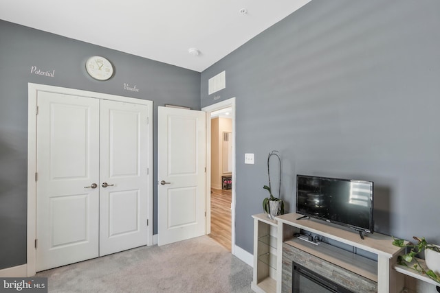 interior space with light colored carpet and a closet