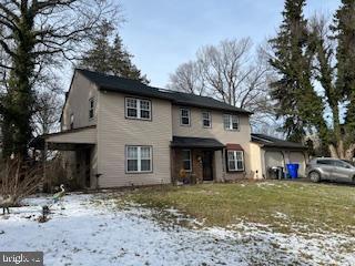 front of property featuring a garage and a yard