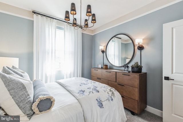 carpeted bedroom with a notable chandelier