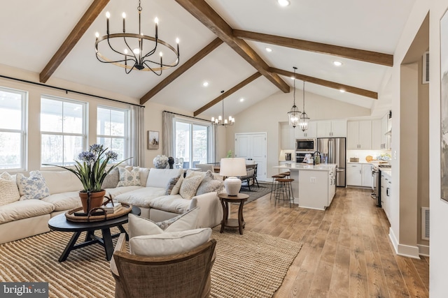 living room with an inviting chandelier, beam ceiling, light hardwood / wood-style flooring, and high vaulted ceiling