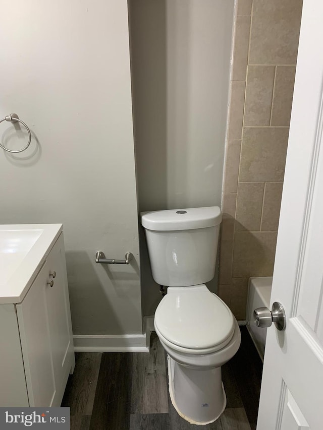 bathroom featuring hardwood / wood-style flooring, vanity, and toilet