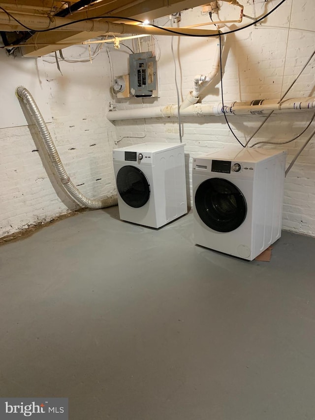 laundry area featuring electric panel and washer and clothes dryer