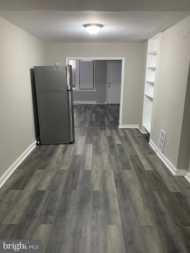 corridor featuring dark wood-type flooring