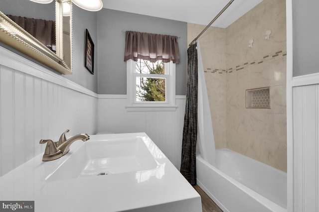 bathroom featuring sink and shower / bath combination with curtain