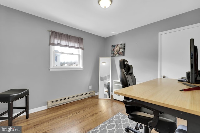 office with a baseboard heating unit and light wood-type flooring