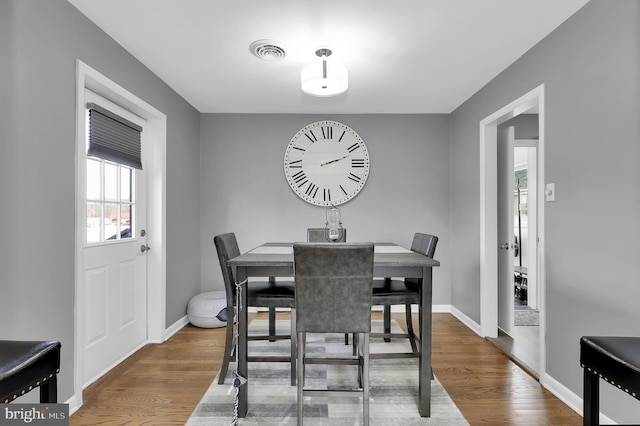 dining room with wood-type flooring