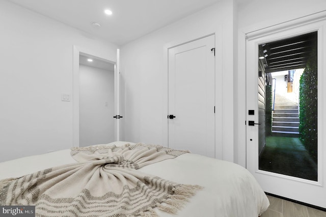 bedroom with a closet, recessed lighting, and light wood-style floors