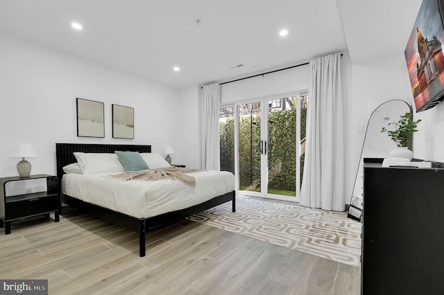 bedroom featuring light wood-type flooring and recessed lighting