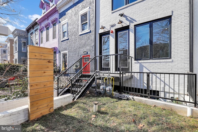 doorway to property featuring brick siding