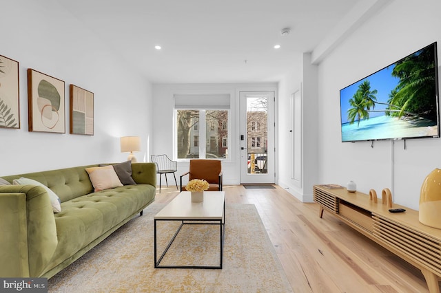 living room featuring light wood finished floors and recessed lighting