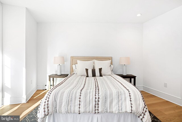 bedroom with wood-type flooring