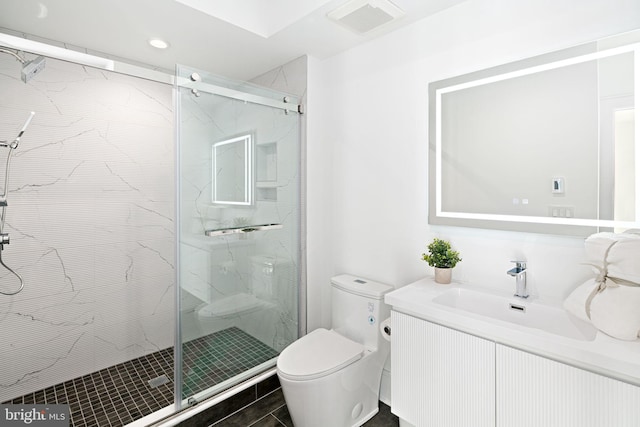 bathroom featuring vanity, an enclosed shower, and toilet