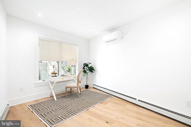 office area featuring hardwood / wood-style floors, a wall mounted AC, and baseboard heating