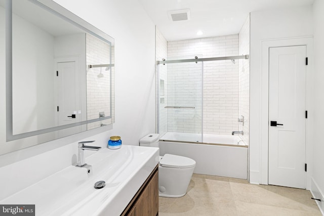 full bathroom featuring toilet, vanity, and bath / shower combo with glass door