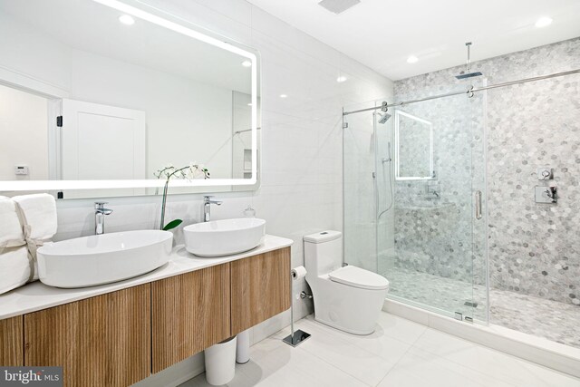 bathroom with vanity, toilet, and an enclosed shower