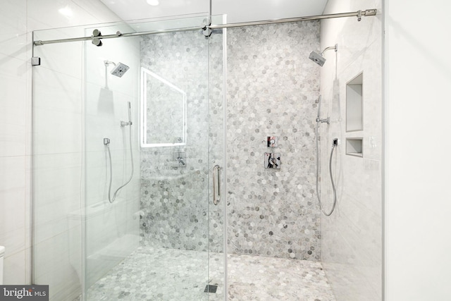 bathroom with a shower with door