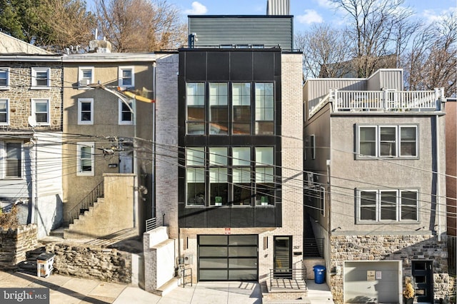 view of front of house with a garage and a balcony