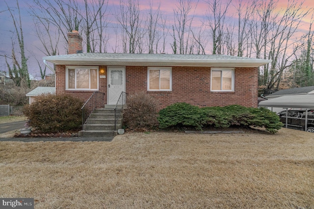 view of front of home featuring a yard and a carport