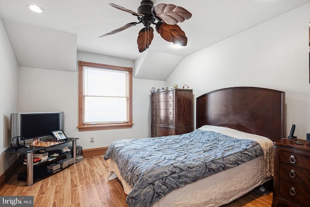 bedroom with vaulted ceiling, light hardwood / wood-style floors, and ceiling fan