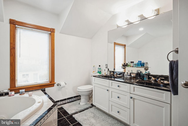 bathroom featuring a relaxing tiled tub, tile patterned floors, vanity, and toilet