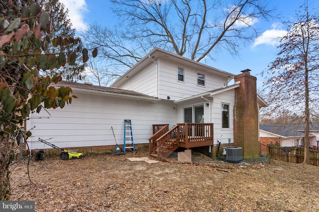 rear view of house with a deck and central air condition unit