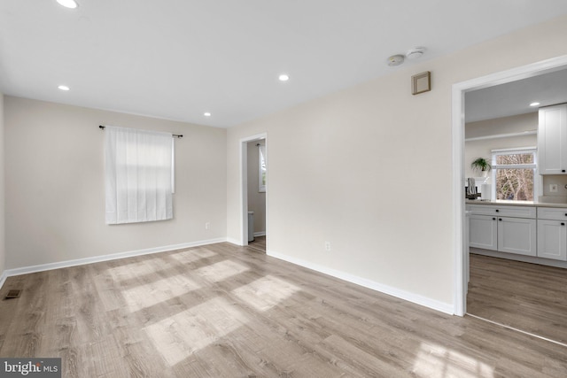 spare room featuring light wood-type flooring