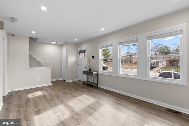 interior space with light hardwood / wood-style floors and a wealth of natural light