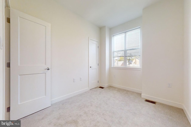 unfurnished bedroom featuring light carpet