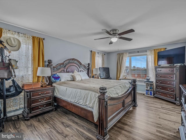 bedroom with ceiling fan and hardwood / wood-style floors