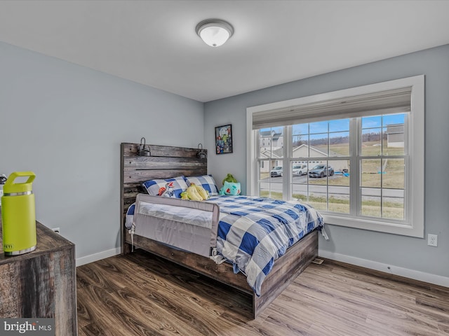 bedroom with hardwood / wood-style floors