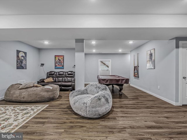 living room with dark hardwood / wood-style flooring and billiards