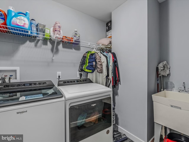 laundry room featuring washing machine and dryer and sink