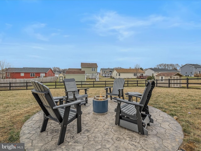 view of patio / terrace with a fire pit and a storage unit