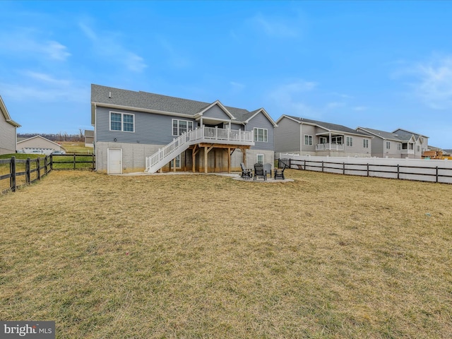 rear view of property with a patio area, a deck, and a lawn