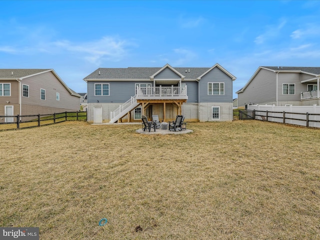 rear view of house featuring a wooden deck, a yard, and a patio