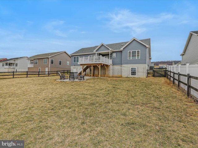 rear view of house featuring an outdoor fire pit, a lawn, a patio area, and a deck