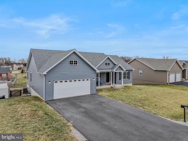 view of front facade featuring cooling unit, a garage, a front lawn, and covered porch