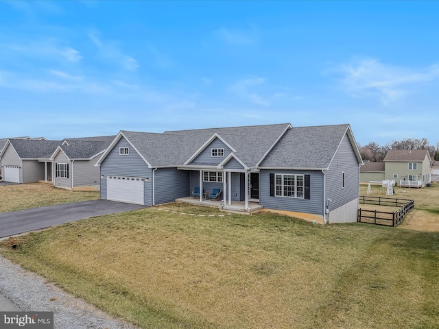 view of front of house featuring a garage, a porch, and a front lawn