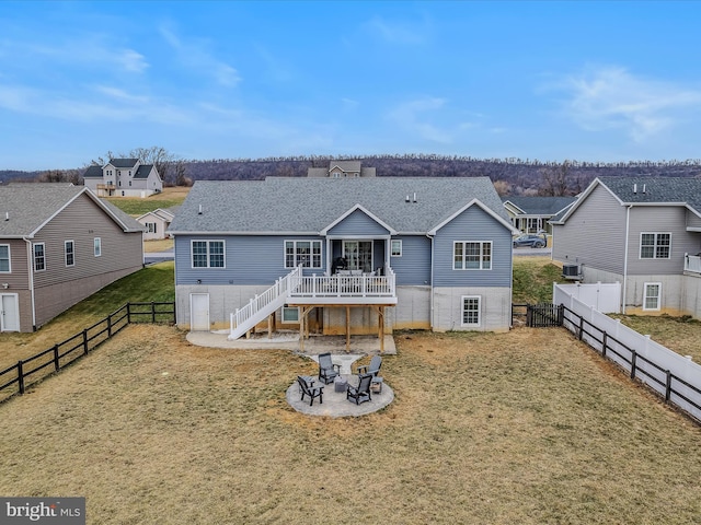 rear view of house featuring a patio, a deck, and a lawn