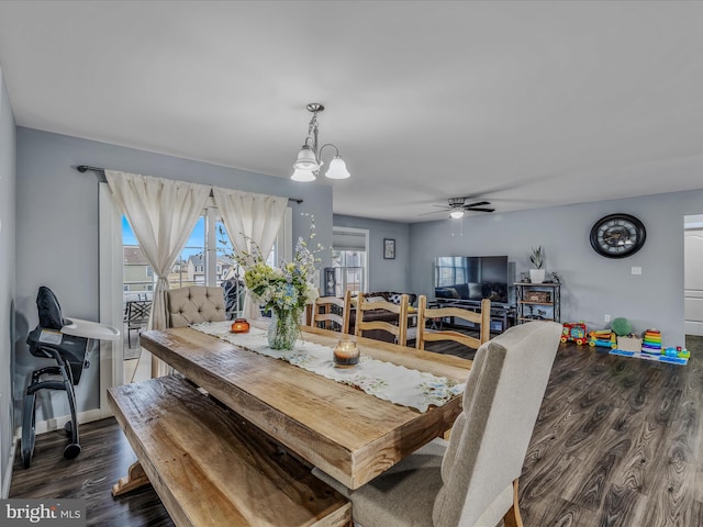 dining room featuring dark hardwood / wood-style floors and ceiling fan with notable chandelier