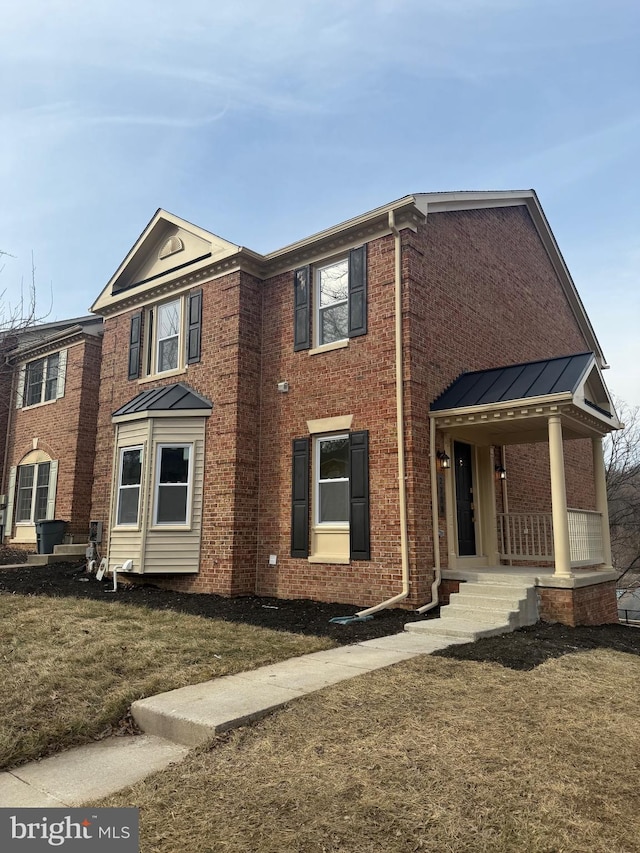 view of front of property with a porch and a front yard