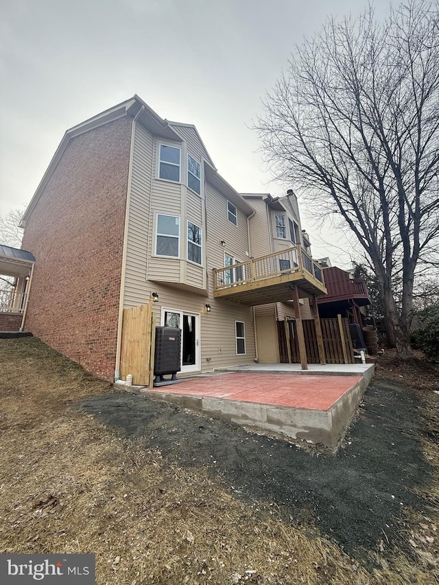 rear view of house featuring a lawn and a patio