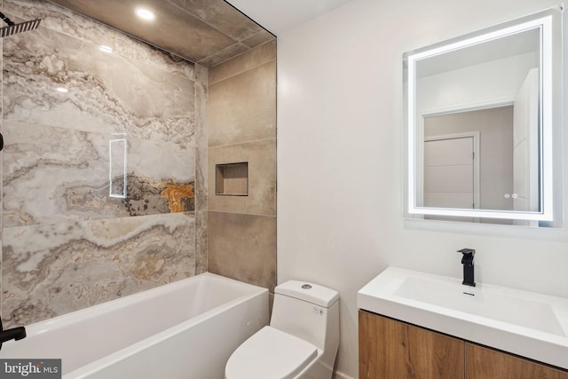 full bathroom with vanity, tiled shower / bath combo, and toilet