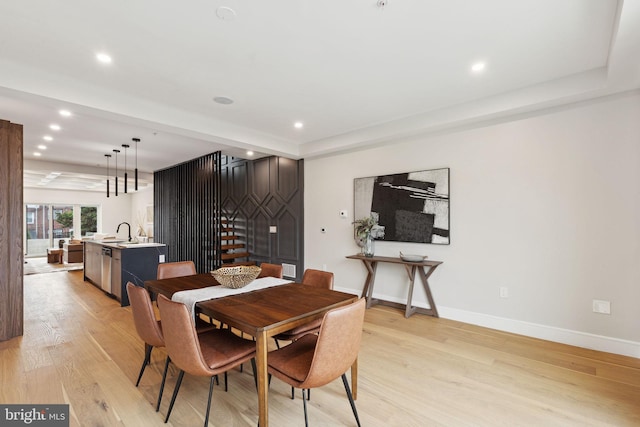 dining area featuring sink and light hardwood / wood-style flooring