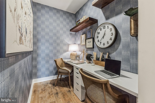 office area featuring built in desk and light hardwood / wood-style floors