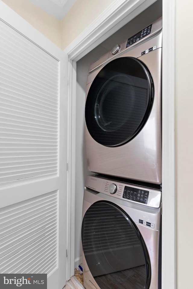 washroom featuring stacked washer and dryer