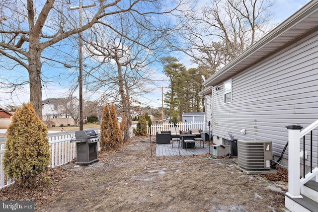 view of yard featuring a wooden deck, an outdoor hangout area, and central AC unit