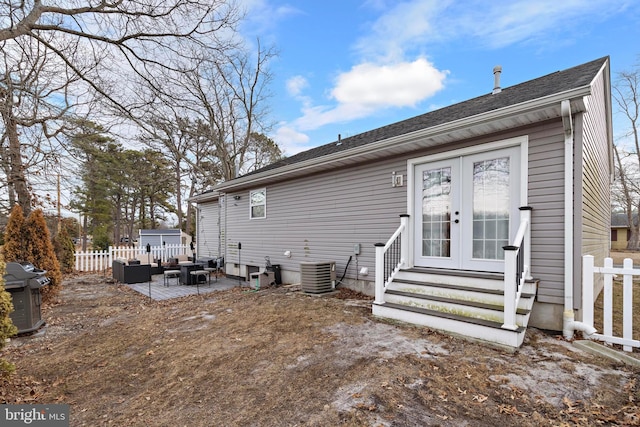 rear view of house with french doors, a patio, and cooling unit