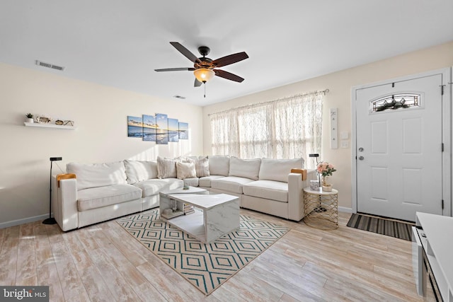 living room featuring ceiling fan and light hardwood / wood-style floors