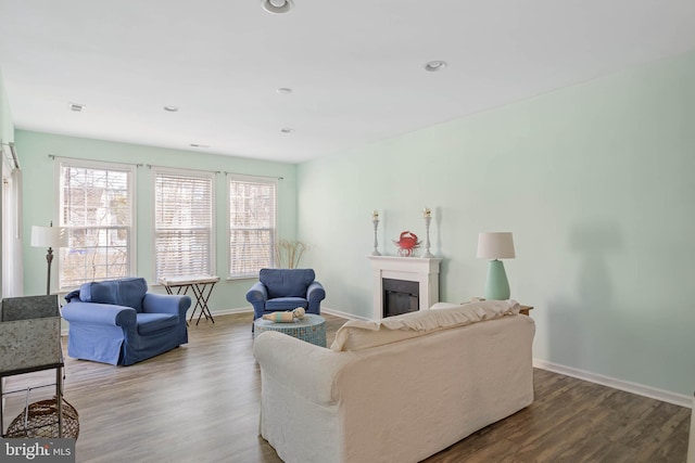 living room with recessed lighting, a fireplace, wood finished floors, and baseboards